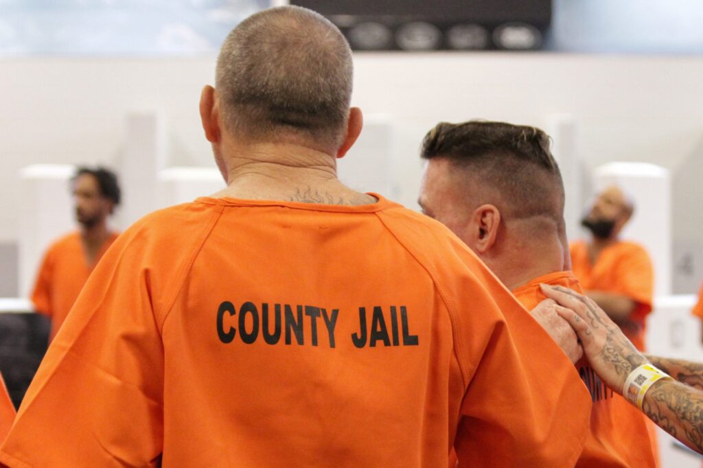 Inmates inside the county jail in orange jumpsuits